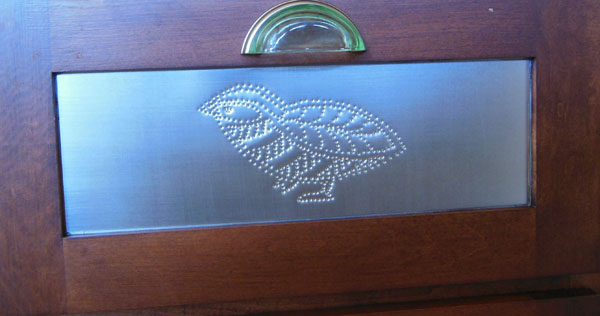 Hand punched pin door panel