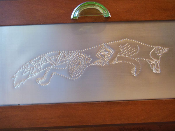 Hand punched pin door panel